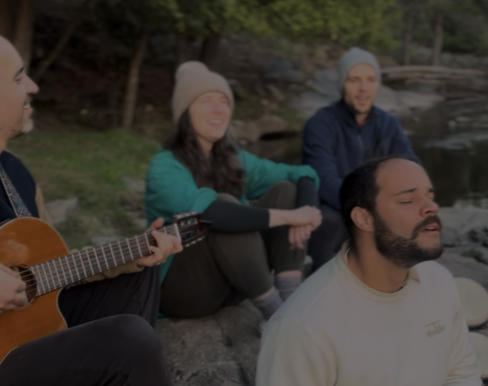 People singing together by the water
