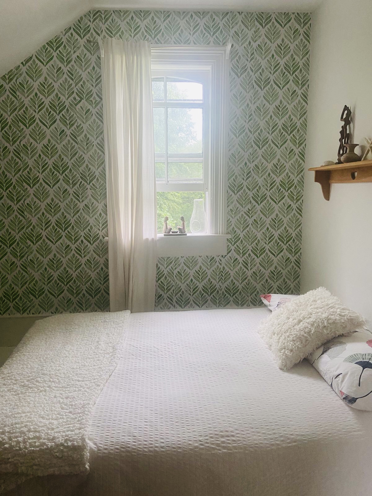 Cozy bedroom with botanical wallpaper